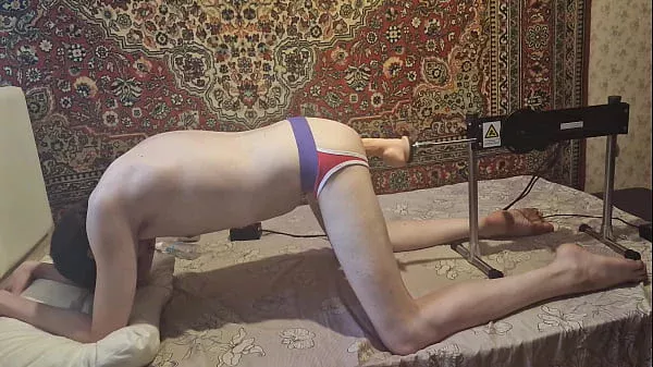 Cute gay having sex with a fuck machine